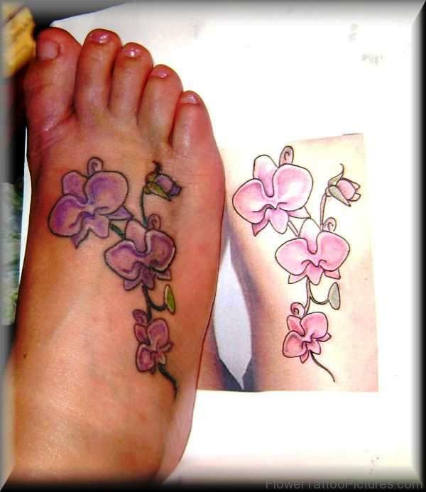Delightful Pink Orchid Flower Tattoo On Foot
