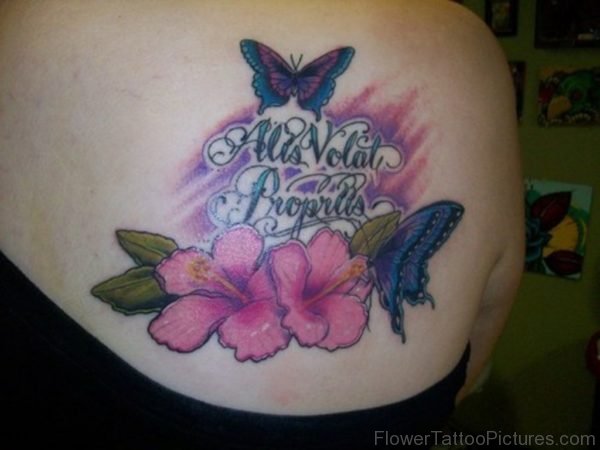 Butterfly tattoos with hibiscus flowers and lettering on back shoulder