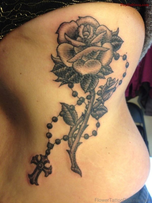Black And Grey Rose With Rosary Cross Tattoo On Side Rib