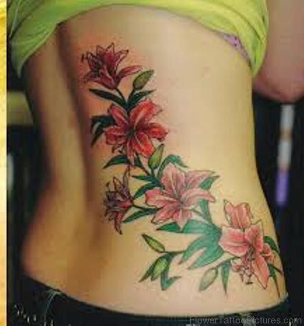 Colorful Amaryllis Flowers Tattoo On Rib