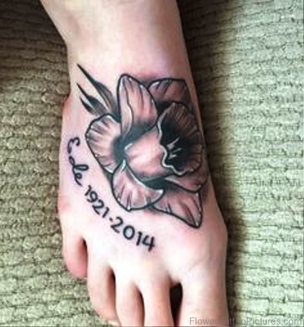 Black And Grey Daffodil Tattoo On Foot