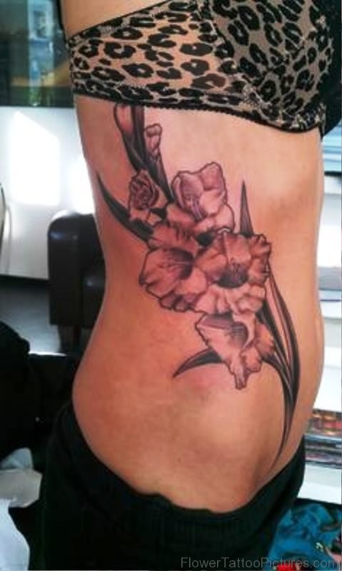 Impressive Gladiolus Flower Tattoo On Rib