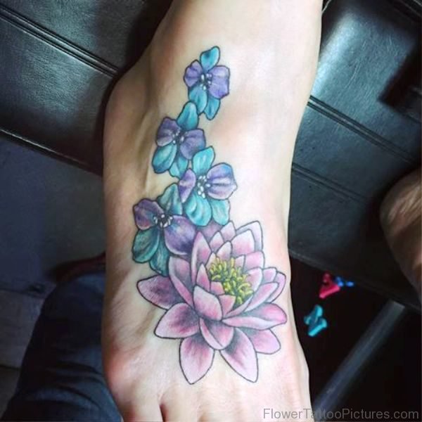 Larkspur Flowers With Lotus Tattoo On Foot