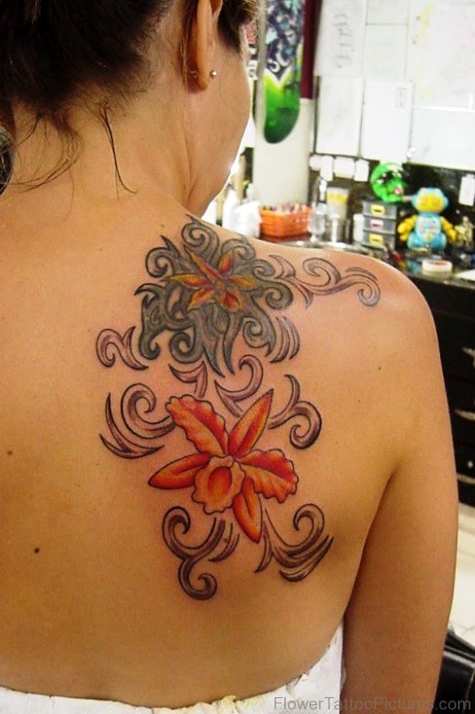 Nice Orange Orchid Flower Tattoo On Shoulder