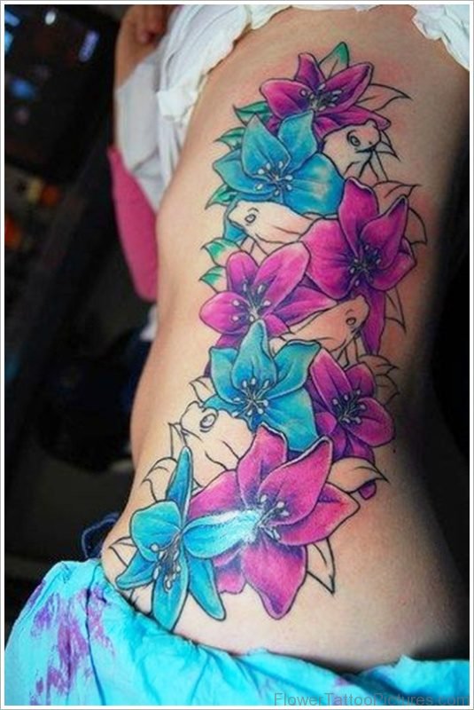 Purple And Blue Orchid Flowers Tattoo On Rib