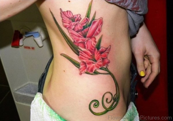 Red Gladiolus Flower Tattoo On Rib